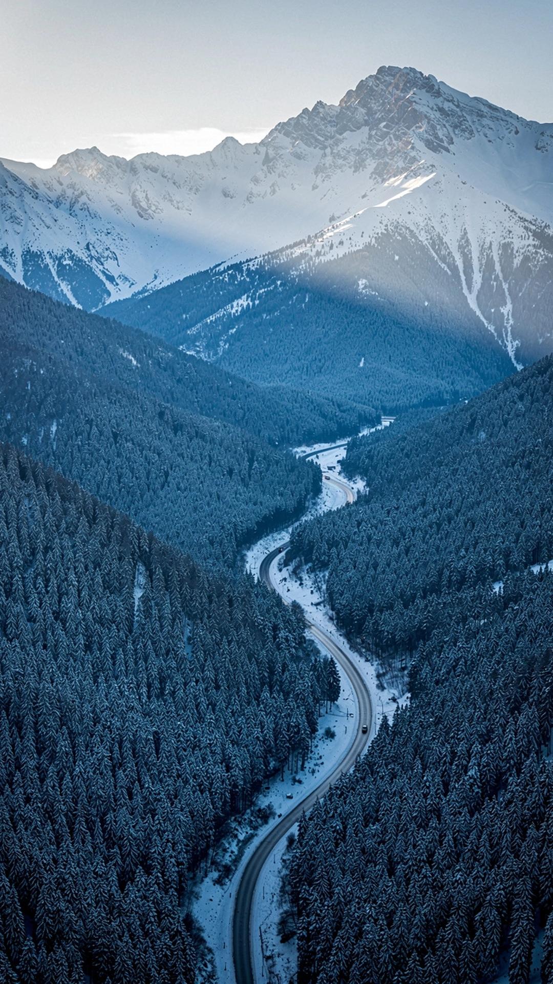 Snow covered Carpathian ridge above a forested valley near Bukovel